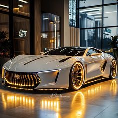 a white sports car parked in front of a building with lights on it's sides