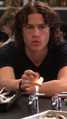 a man sitting at a table with food in front of him