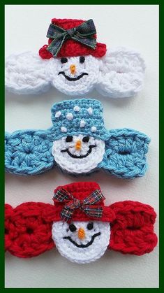 three crocheted snowmen with hats and bows