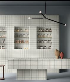 an empty counter in a store with shelves full of bottles and vases on it