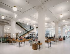 an empty lobby with tables and chairs in it