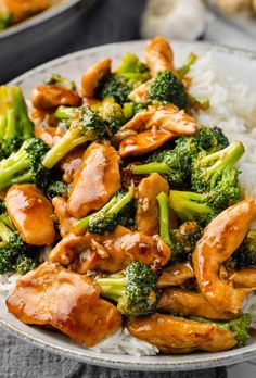 chicken and broccoli stir fry on top of rice in a white bowl with chopsticks