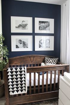 a baby's crib with pictures on the wall