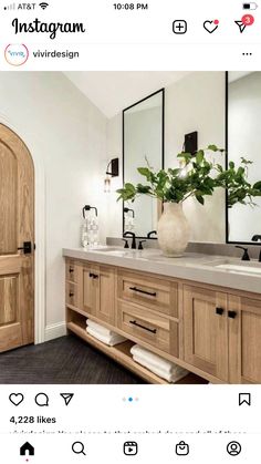 a bathroom with two sinks and mirrors on top of the counter, next to an open door