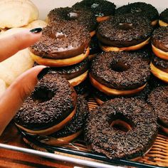 there is a basket full of chocolate donuts