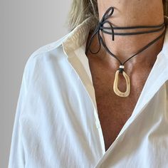 This super chic cord choker has an abstract charm made of shell like resin.  It will uplift your summer look whether for daytime or night occasions. The dark grey cord is extra long (170cm) so that it can be worn as a choker or a long necklace, as you prefer. Being made of super soft suede cord and a lightweight pendant, it is very comfortable to wear. Pendant size: 2.5cm/1"(W) x 4cm/1.6"(H) Minimalist Adjustable Choker For Summer, Minimalist Adjustable Necklaces For Beach, Modern Necklaces With Adjustable Cord For Gift, Chic Adjustable Choker For Summer, Chic Adjustable Necklaces For Beach, Modern Necklace With Adjustable Cord As Gift, Adjustable Minimalist Choker For Summer, Chic Handmade Choker For Gift, Chic Handmade Necklaces