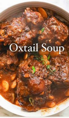 an oxtail soup in a white bowl with the words oxtail soup above it