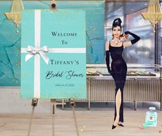 a woman in a black dress is standing next to a sign that says tiffany's bridal shower