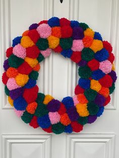 a multicolored wreath hanging on the front door