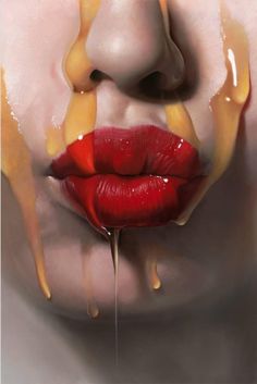 a woman's lips are dripping with yellow and red liquid on them, as if it were melted