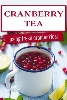 Cranberry tea and cranberries in a white metal mug on a wooden table surrounded by cranberries and lime slices. The text says cranberry tea using fresh cranberries. Cranberry Tea Benefits, Cranberry Tea, Thanksgiving Snacks, Hot Drinks Recipes, Alcohol Free Drinks, Cranberry Fruit, Herbal Teas Recipes, Autumn Tea, Festive Drinks