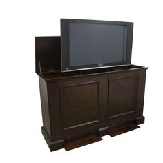 a flat screen tv sitting on top of a wooden cabinet