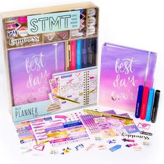 an assortment of stationery items including pens, notebooks and stickers in a box