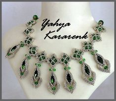 a green and white necklace on a mannequin with the word yyfa35