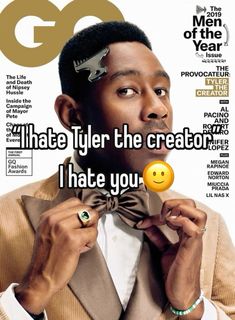 a man in a suit and bow tie on the cover of gq magazine with an emoticive smiley face