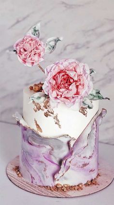 a marble cake with pink flowers on top