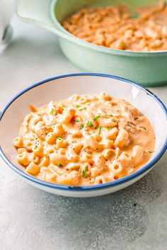 a bowl filled with macaroni and cheese on top of a table