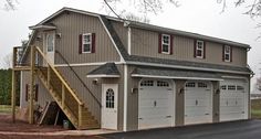 a two story garage with stairs leading up to it