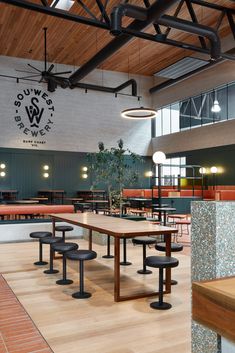 an empty restaurant with wooden tables and benches