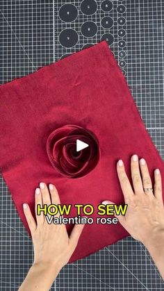 someone is making a flower out of red fabric