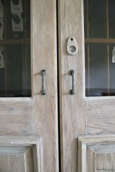 two wooden doors with metal handles and locks