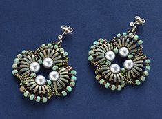 two pairs of earrings with pearls and beads on blue background, close up view photo