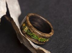 a wooden ring with green moss on it