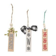 three wooden tags hang from twine with bows and snowflakes on them, one has the letter w