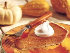 a plate topped with pancakes covered in whipped cream next to other fall decorations and pumpkins