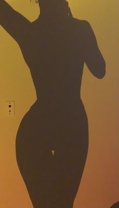 the silhouette of a woman is shown against an orange and yellow background