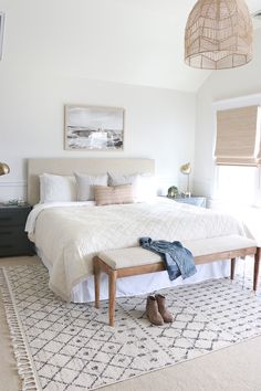 a bedroom with a large bed and white walls