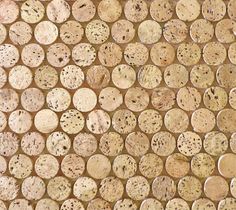 a wall made out of wooden logs with holes in the middle and dots on it