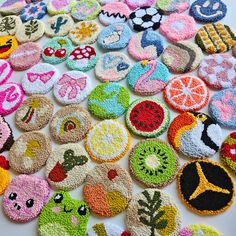 a pile of crocheted buttons sitting on top of a white table next to each other