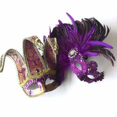 The women's mask is adorned with lavish deep purple feathers that add a dimension of opulence and sophistication, complemented by a sparkling brooch and gems for sparkle. The men's jester mask comes in two styles and exudes playfulness and regal allure, capturing the essence of a royal entertainer with a touch of mystique. This purple mask set is perfect for masquerades or festivals! Age Group/Gender - Adult/Unisex Size/Type - One size fits all adults Mask Color - Purple/Gold Mask Material - Pol Purple Masquerade Mask, Ball Event, Couples Masquerade Masks, Jester Mask, Mask Venetian, Metal Mask, Mask Style, Female Mask, Gold Mask