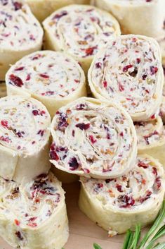 cranberry cheese rolls on a cutting board with rosemary sprigs