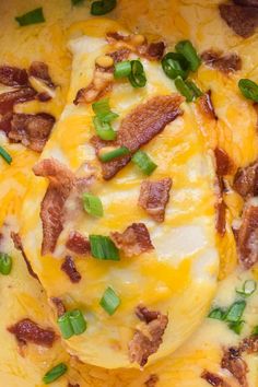 a casserole dish with cheese, bacon and green onions