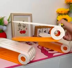 a pair of scissors are being used to cut paper with scissors on a table next to flowers