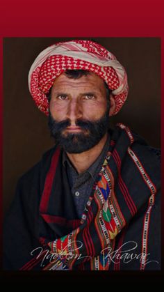 a man with a beard wearing a red and white hat