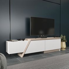 a flat screen tv sitting on top of a white entertainment center