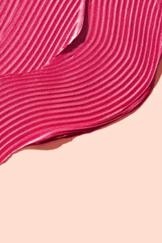 a close up view of a pink fabric material with wavy lines on the top and bottom