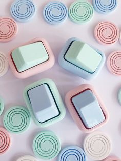 several small square dishes sitting on top of a table covered in circles and shapes,