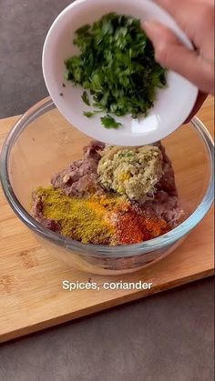 someone is adding seasonings to their food in a bowl on top of a cutting board