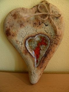 a heart shaped rock hanging on a wall