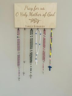 "A great addition to your prayer corner to display all of your family rosaries! You decide what gets engraved under the leaf image! This rosary holder is 15\" x 8\" x 0.5\" and is laser engraved on birch wood. You decide how many hooks you would like. The photo for this listing shows 6, but up to 8 can easily be added. Each rosary holder comes with a sawtooth hook installed for easy hanging. Each piece of wood has its own knots and color variations, which will make each rosary holder unique. *rosaries not included" Catholic Prayer Corner, Rosary Holder, Catholic Christmas Gifts, Home Altar Catholic, Catholic Christmas, School Prayer, Prayer Corner