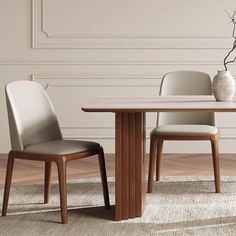 a dining table with two chairs and a vase on the floor in front of it