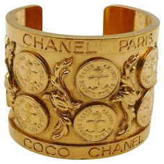 CHANEL by KARL LAGERFELD and VICTOIRE DE CASTELLANE vintage cuff bracelet featuring CC 31 Rue Cambon Paris Coins alterning with acanthus leaves and embossed C H A N E L P A R I S C O C O C H A N E L on the rims. Gold tone metal hardware. Collection n°23 (year : 1988). Embossed CHANEL 2 3 Made in France. Indicative measurements : inner measurements approx. 5.8 cm x 4.7 cm (2.28 inches x 1.85 inches) / width approx. 5.2 cm (2.05 inches). NOTES - This is a preloved item, therefore it might have imp 31 Rue Cambon, Victoire De Castellane, Vintage Cuff Bracelet, Crystal Belt, Acanthus Leaves, Chanel 2, Chanel Vintage, Chanel Jewelry, Gold Chain Jewelry