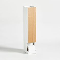 a white toilet paper dispenser with wood on the top and bottom part