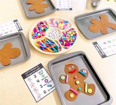 gingerbread cutouts are displayed on trays for children to make