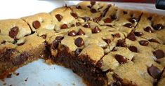 chocolate chip cookie bars cut in half on top of a white plate with one piece missing