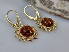 Welcome to handmade Baltic Amber jewelry shop. This Item is made of genuine, natural Amber. This item will make You look simple but gorgeous it also can be impressive gift for a woman: sister, mother, wife, girlfriend or best friend.  Wrapped as a birthday gift. Sun shape earrings. Brown Baltic amber jewelry. Handmade Amber earrings, lever back closure. Real gemstone dangle earring. Crystal hanging earrings with nice gift wrapping. Flaming sun shape can be summer fashion look.   Gold plated ster Faberge Jewelry, Crystal Hanging, Baltic Amber Jewelry, Headpiece Jewelry, Amber Earrings, Earring Gold, Gift For Sister, Natural Amber, Jewelry Lookbook